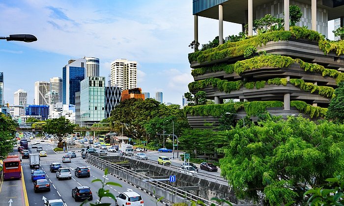 Street view in Singapore with cars and buildings.