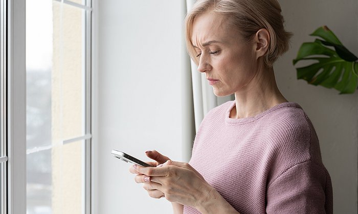 A woman watching at a smartphone