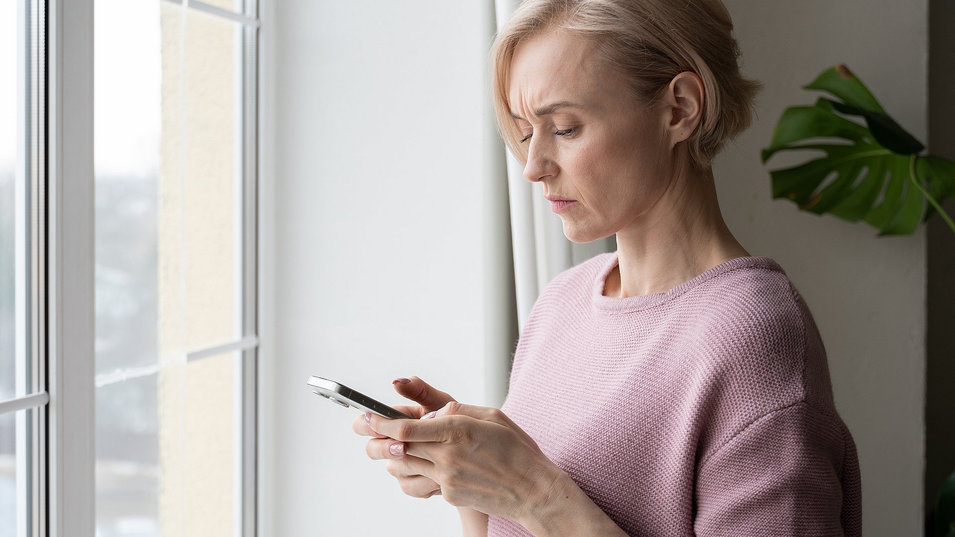 A woman watching at a smartphone