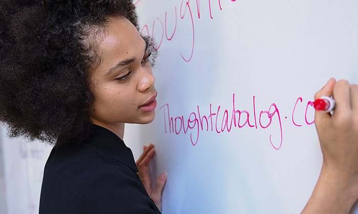 Young woman writing on a whiteboard