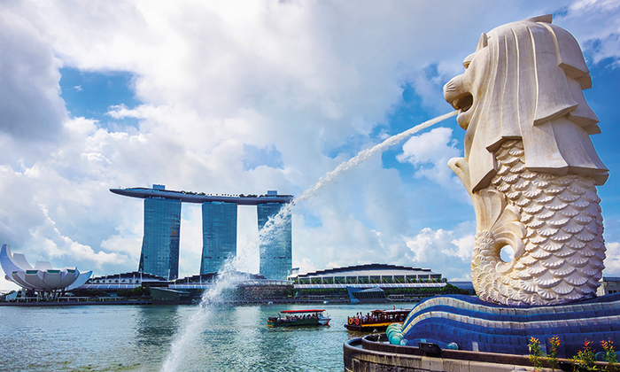 View of Merlion statue, symbol of Singapore, with famous Marina Bay Sands hotel in the background.