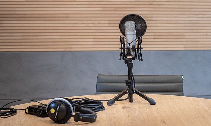 Recording equipment on a table, including a large microphone